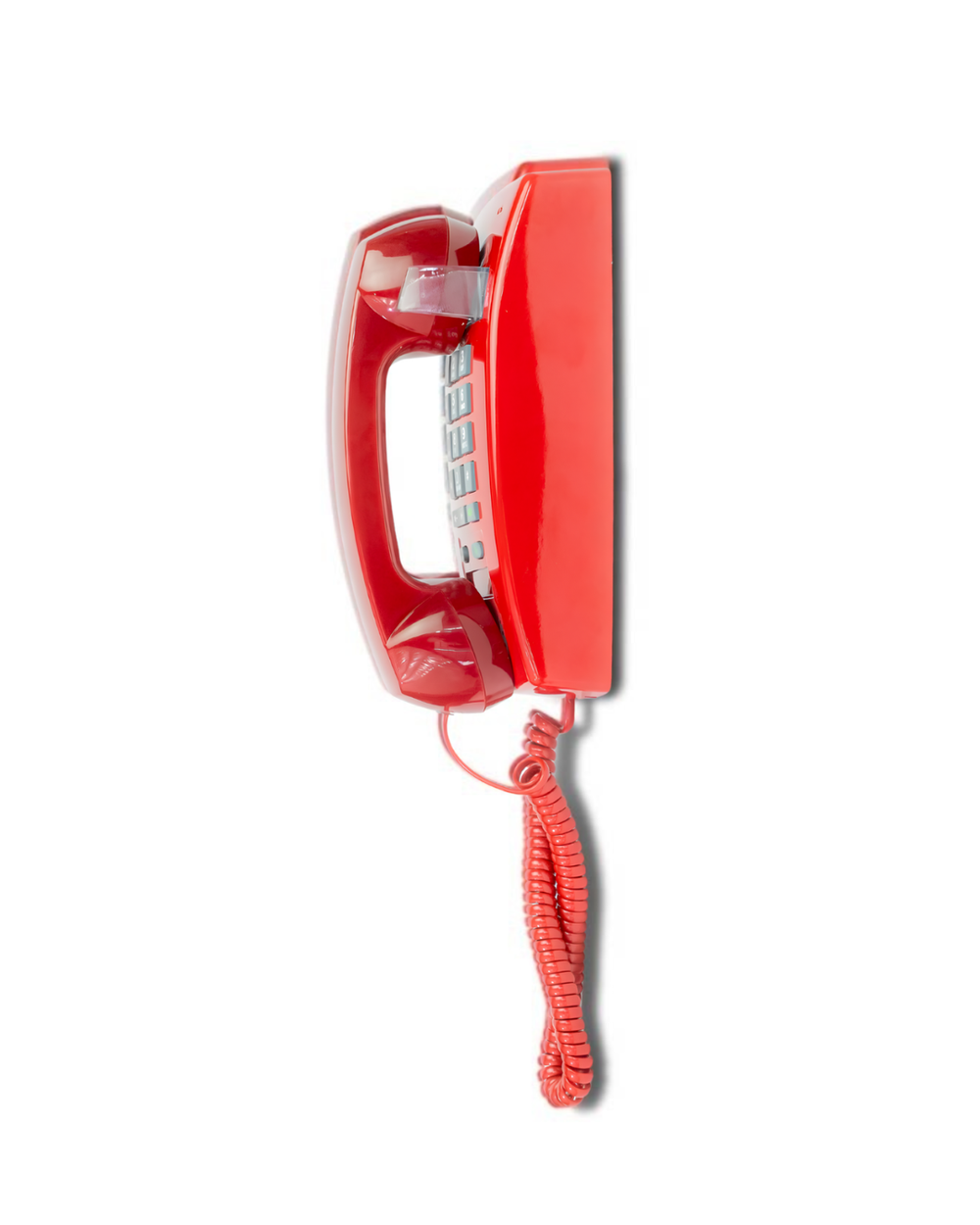 Red wall phone mounted on a white wall
